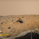 The Pathfinder spacecraft and Sojourner rover, which can be seen investigating a large rock.